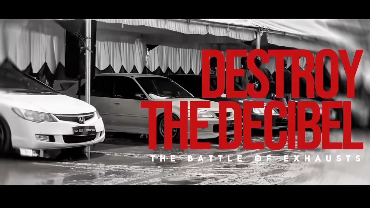 Opening frame of the trailer: cars lined up under a marquee with the title Destroy The Decibel — The Battle of Exhausts